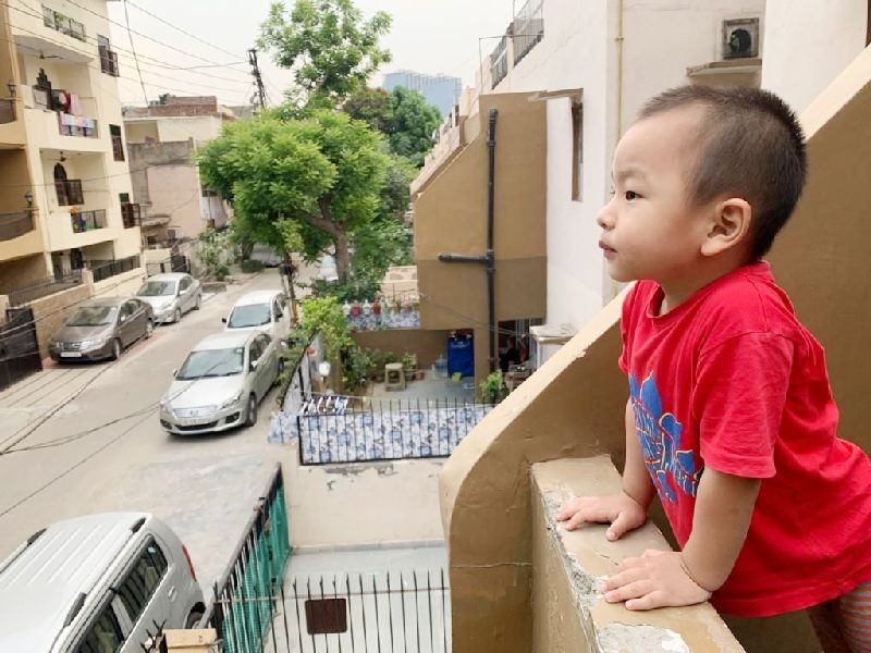 'When will the lockdown end?' A small boy from the NE watches the outside world from a balcony as his mother, a medical frontline worker, leaves for work in a suburb in Delhi. The locality in which the boy’s parents reside fall under COVID-19 ‘Red Zone.’ 
